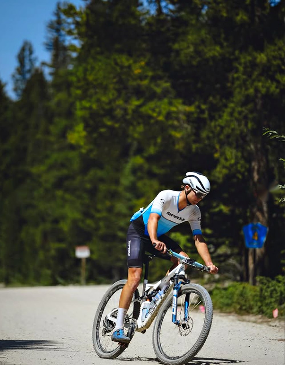Racer cornering a Spry Centaurus on a forest fire road